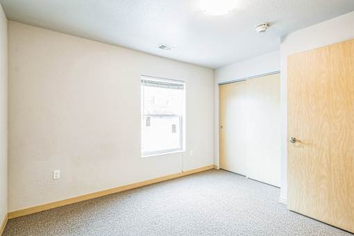 A room with a window and a door.