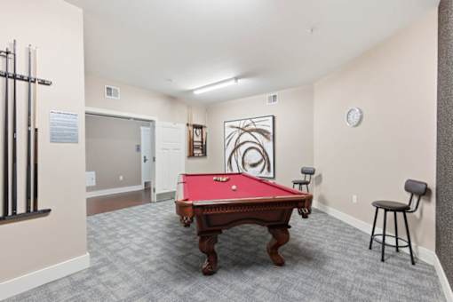 A pool table is in the middle of the room.at The Lodge at Johns Road Apartments, Huntsville, AL, 35806