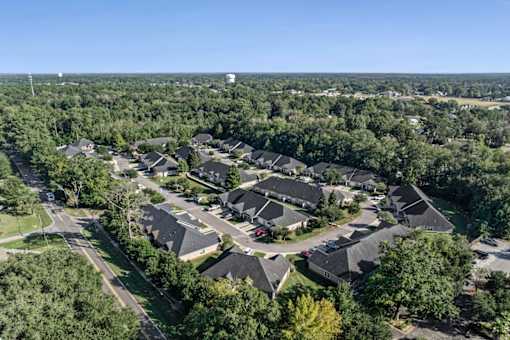 A bird's eye view of a residential area with houses and trees.