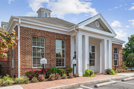 The outside of Centerville Manor's clubhouse with lush landscaping