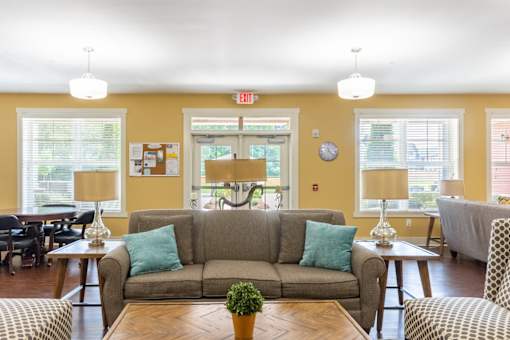 A living room with a grey couch and a coffee table.