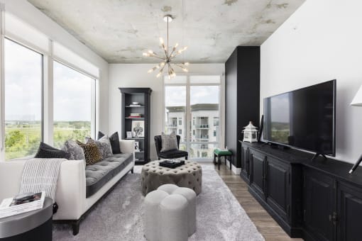 large living room with floor to ceiling windows at Lake Nona Pixon, Orlando, FL