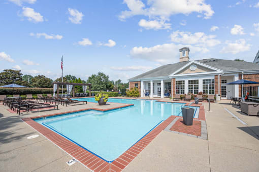 a large swimming pool and sundeck by the clubhouse at Centerville Manor