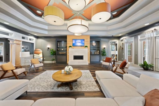 large clubhouse at Fenwyck Manor Apartments with fireplace, tv, and ample comfortable seating