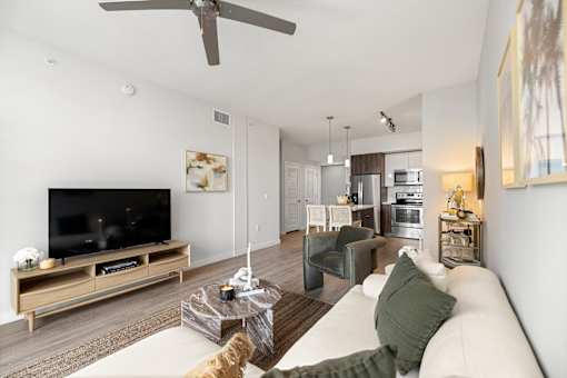 A modern living room with a white couch and a wooden coffee table.