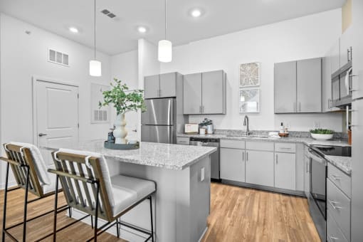 a kitchen with stainless steel appliances and a marble counter top