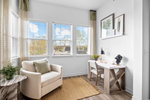 a living room with a couch and a table and windows