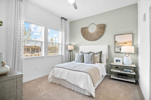 a bedroom with a bed and two windows