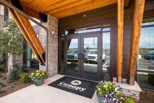 the front door of a canyon car dealership with a welcome mat on the sidewalk