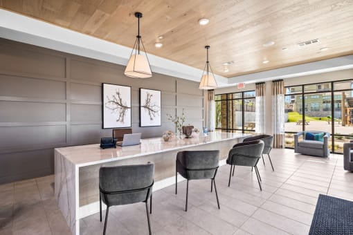 a large kitchen with a long counter and chairs