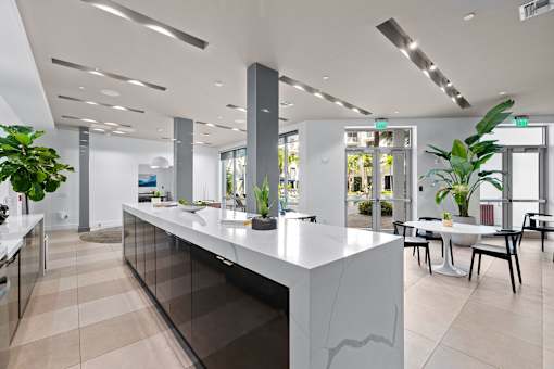A white reception desk with a glass panel in the middle.