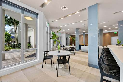 A modern office space with a table and chairs.