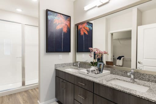 Designer bathroom with granite countertops and double sinks at Residences at The Green in Lakewood Ranch, FL