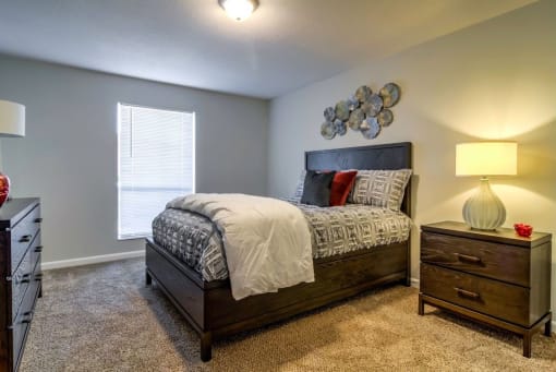 bedroom with plush carpet, window, overhead lighting and model furnishings at The Onyx Hoover