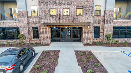 a car parked in front of a brick building