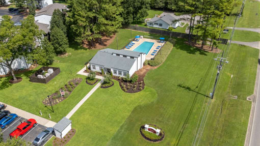 an aerial view of a house and yard with a swimming pool