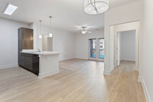 a renovated living room and kitchen with a large open floor plan