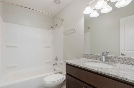 a bathroom with a sink toilet and bathtub in apartment at The Onyx Hoover