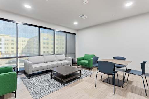 a living room with a couch and a table and chairs