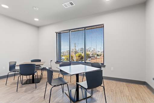 a dining room with a large window and tables and chairs