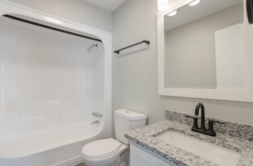a bathroom with a sink, toilet, and shower/bathtub