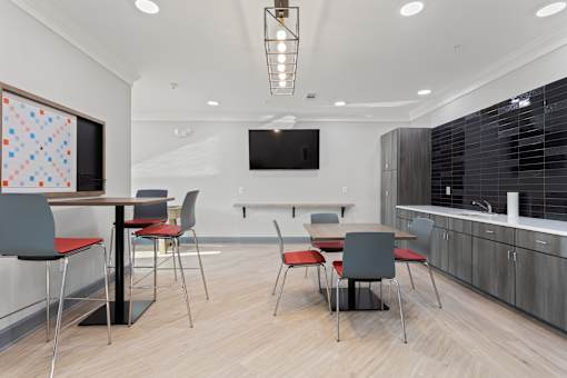 a conference room with a table and chairs and a television