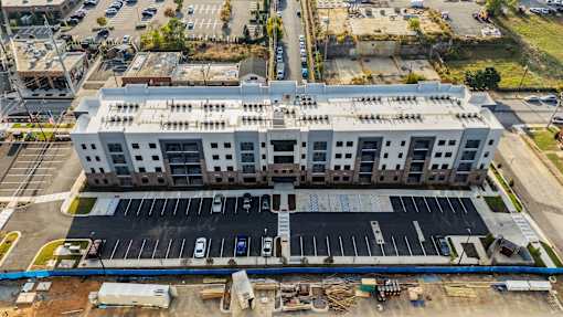 an aerial view of a large building in a parking lot
