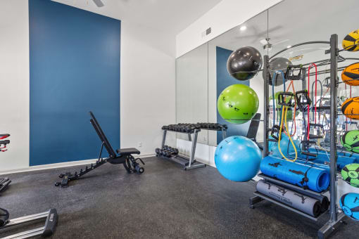 the gym with weights and other exercise equipment at the flats