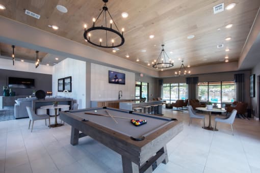 the large lounge area including a pool table in the clubhouseat Canopy Park Apartments, Alabama