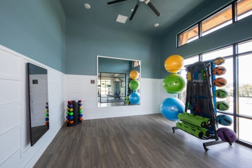 The yoga and stretching studio with medicine balls and yoga equipment at Canopy Park Apartments, Alabama, 35124