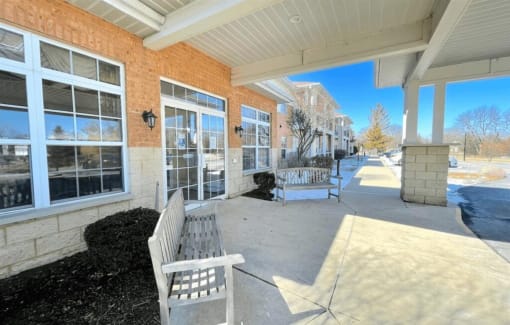 covered benches outside the entrance to Algonquin Manor Senior Apartments