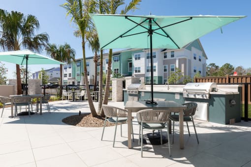 picnic tables and umbrellas beside luxury grilling areas at Lake Nona Concorde