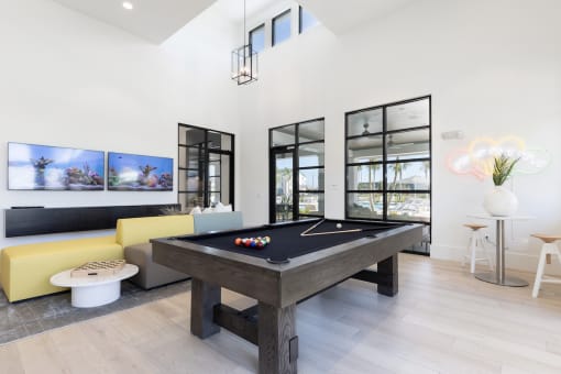 a pool table and sofa in Lake Nona Concorde clubhouse