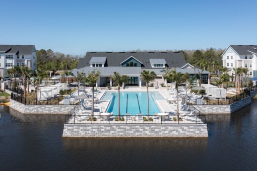 Lake Nona Concorde's pool, sundeck, and clubhouse beside the pond