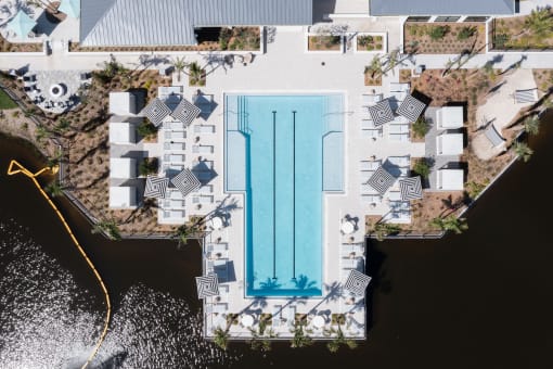 an aerial view of the pool and sundeck beside the pond at Lake Nona Concorde