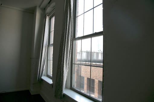 large windows with curtains in loft apartment at Goodall-Brown Lofts, Birmingham