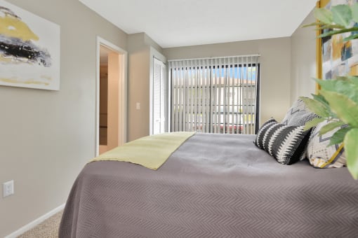 a bedroom with a large bed and a large window