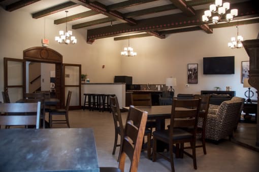 a dining room with tables and chairs and a living room