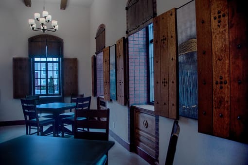 a dining room with tables and chairs and wooden doors