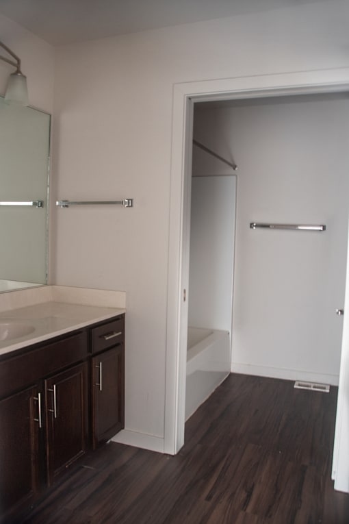 an empty bathroom with a sink and a mirror and a toilet