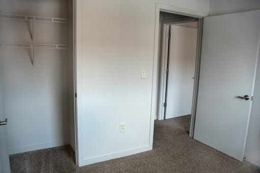 a room with a closet and a mirror in it