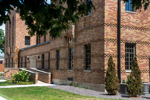 a brick building with a tree in front of it