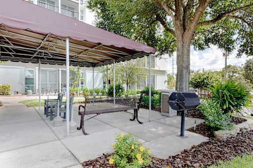 A park area with a bench and a mailbox.