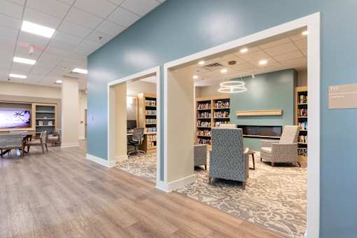 A library with bookshelves and chairs.