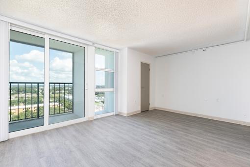 A room with a view of the city through the window.