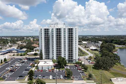 A tall white building with a sign on the top of it.