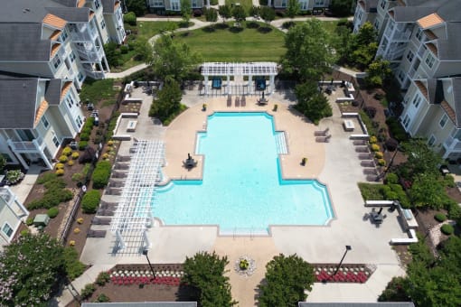 an aerial view of the swimming pool and sundeck surrounded by residential buildings at Fenwyck Manor Apartments