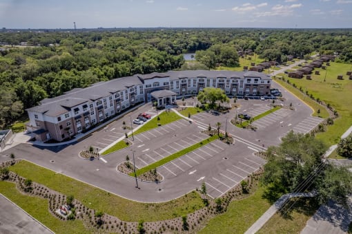 an aerial view of a large parking lot and a large building