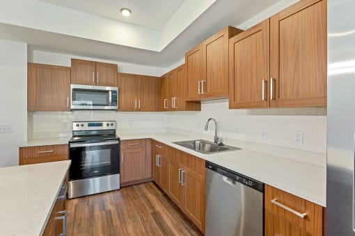 a kitchen with wooden cabinets and stainless steel appliances