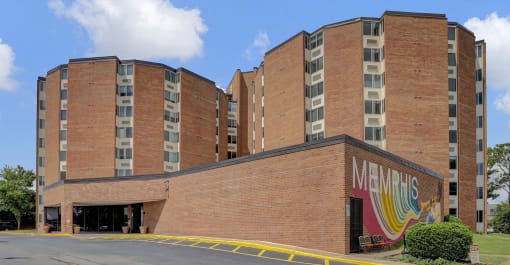 a large brick building with a mural on the side of it